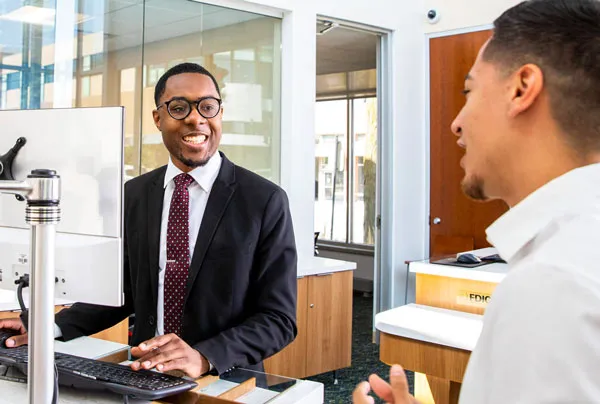 Image - A bank employee speaking with a customer.